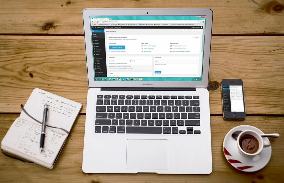 A polished office desk arrangement showcasing Apple products: iMac, MacBook, and iPad.